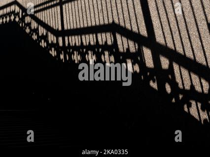 Shadows of staircase with ornate balustrades and railings. Stock Photo