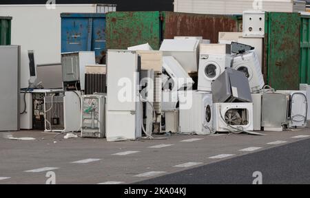 Old electrical appliances in container of recycling center. Electronic waste for recycling. Discarded household appliances in the garbage container. Stock Photo