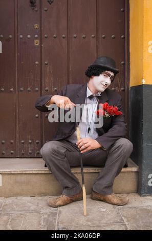 Seated street performer in doorway, Seville, Spain. Stock Photo