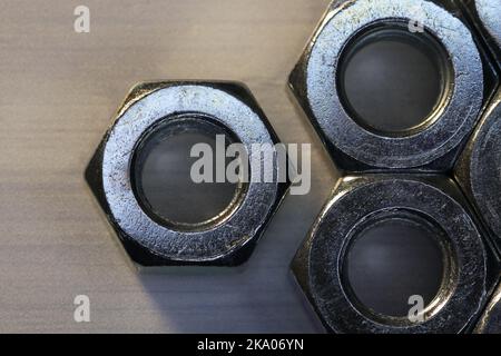 Metal Hex Nuts Close-up On Textured Surface Stock Photo