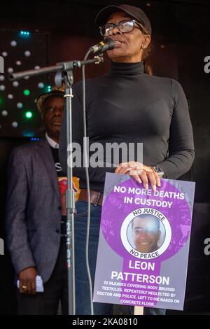 London, UK. 29th October, 2022. Stephanie Lightfoot-Bennett, twin sister of Leon Patterson, addresses fellow campaigners from the United Families & Friends Campaign (UFFC) outside Downing Street following their annual procession in remembrance of family members and friends who died in police custody, in prison, in immigration detention or in secure psychiatric hospitals. Leon Patterson died in November 1992 after spending a week in custody at Stockport police station. There have been 1,838 deaths in police custody or otherwise following contact with the police in England and Wales since 1990. Stock Photo