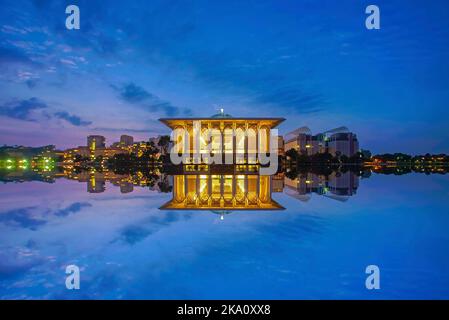 Mirror reflection of beautiful Iron Mosque during blue hour Stock Photo