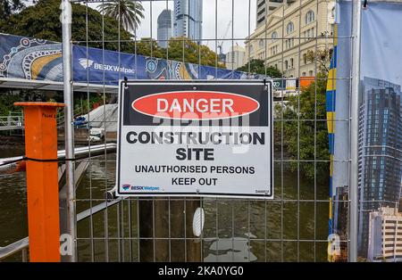 Brisbane, Queensland, Australia - August 2022: Construction site signage warning of danger on the Brisbane River. Stock Photo