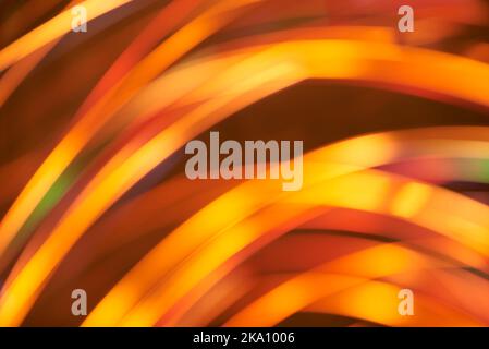 Abstract blur background, dynamic lights in motion, flowing design in warm orange and yellow vivid colors. Stock Photo