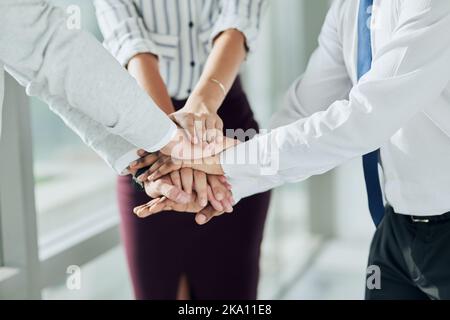 Together is better. Closeup shot of a group of unrecognizable businesspeople joining their hands together in unity. Stock Photo