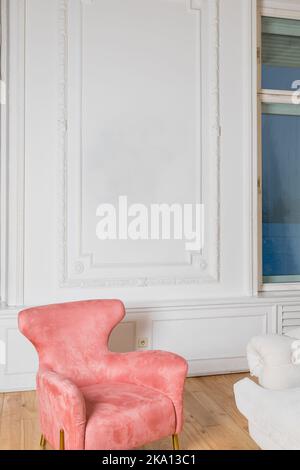 Minimalistic and luxury pastel pink home interior with velvet design armchair, big window.classical style Armchair in vintage room. house interior Stock Photo