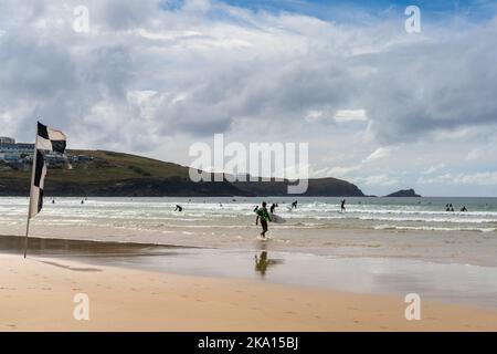 Newquay, United Kingdom - 4 Spetember, 2022: view of Fistral Beach in Newquay with surfers enjoying a summer day in the waves Stock Photo