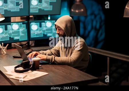 Dangerous hacker working on security breach, creating cyber attack on big data server. Hacking computer system and software, breaking security firewall and stealing company information. Stock Photo