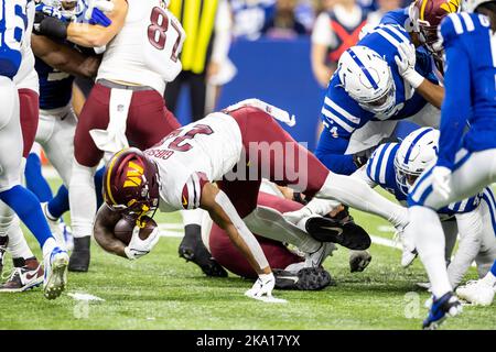 Washington Commanders running back J.D. McKissic (23) is tripped up by  Philadelphia Eagles linebacker Kyzir White (43) during the second half of  an NFL football game, Sunday, Sept. 25, 2022, in Landover