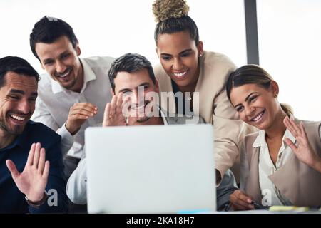 Connect with the world and see your business flourish. a group of businesspeople having a video conference together on a laptop in an office. Stock Photo