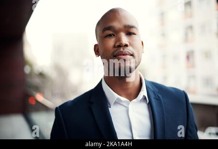 I can confidently say that Ive made it. Portrait of a handsome young businessman standing outside on his office balcony. Stock Photo