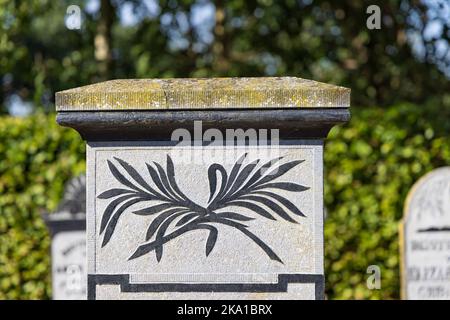 Marum, The Netherlands - September 2, 2022: Old graves with palm tree leaves at graveyard in Marum in municipality Westerkwartier in Groningen province the Netherlands Stock Photo