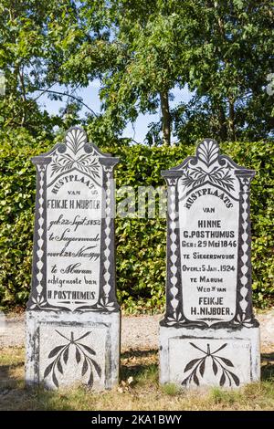Marum, The Netherlands - September 2, 2022: Old graves with palm tree leaves at graveyard in Marum in municipality Westerkwartier in Groningen province the Netherlands Stock Photo