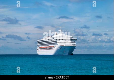 The view of a drifting cruise ship near Half Moon Cay and a picturesque sky in a background (Bahamas). Stock Photo