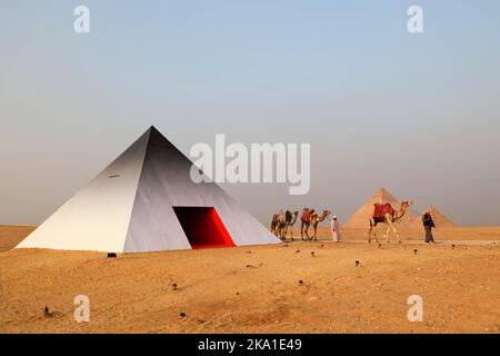 French artist JR’s photo booth in the shape of a pyramid, seen by the pyramids on the Giza Plateau, near Cairo, Egypt, on October 29, 2022 as part of ‘Forever Is Now’ 2nd annual exhibition by ‘Art d Egypte’. Photo by Balkis Press/ABACAPRESS.COM Stock Photo