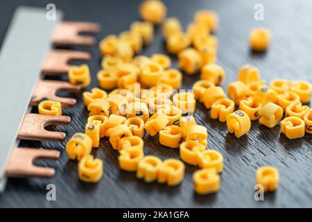 Cable markers scattered on the table, macro shot. Stock Photo