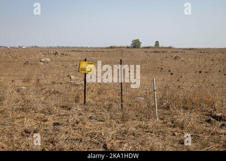 minefield warning sign in Hebrew, English and Arabic, Golan Heights, Israel Stock Photo