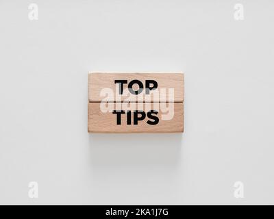 The word top tips on wooden blocks on white background. Stock Photo