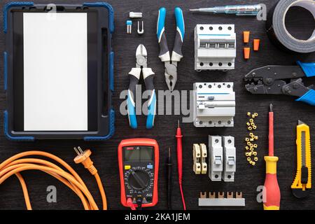 Different electrical tools on wooden background, flat lay. Stock Photo
