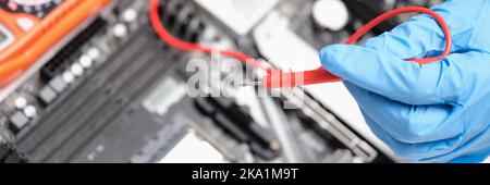 Engineer is testing motherboard chip repair closeup Stock Photo