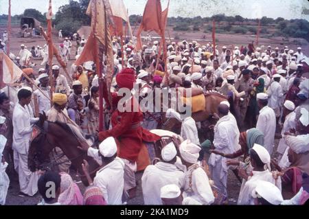 Pandharpur Wari or Wari is a yatra to Pandharpur, Maharashtra, to honor Vithoba. It involves carrying the paduka of a saint in a palkhi, most notably of Dnyaneshwar and Tukaram, from their respective shrines to Pandharpur. Many pilgrims join this procession on foot. Stock Photo