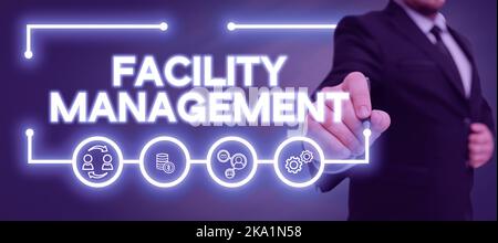Hand writing sign Facility Management. Business approach Understanding Monetary areas like Finance and Investing Man With A Pen Pointing On Digital Stock Photo