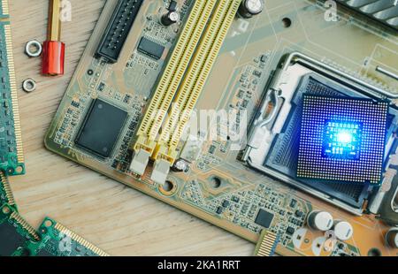 Selective focus computer chip on socket. Chipset on electronic circuit board of PC motherboard at repair workshop. CPU chip. Electronic components. Stock Photo