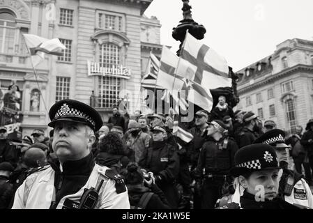 London, UK. March 21, 2015. A bored police officer pulls a face whilst guarding a protest at Piccadilly Circus London. Stock Photo