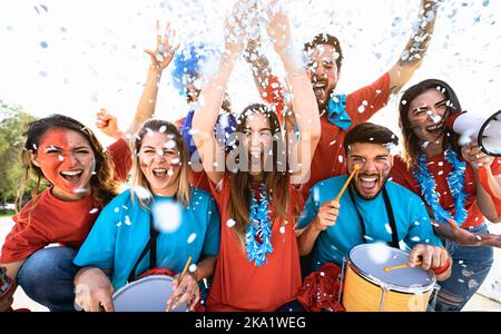 Football fans having fun supporting their favorite team - Soccer sport entertainment concept Stock Photo