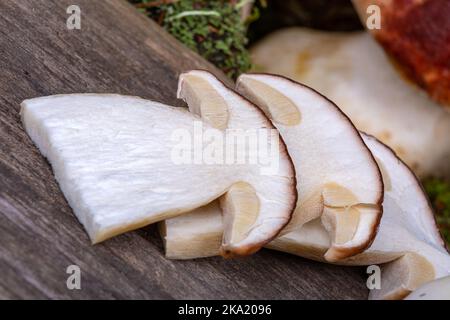 Sliced porcini mushrooms on a wooden background, macro photography Stock Photo