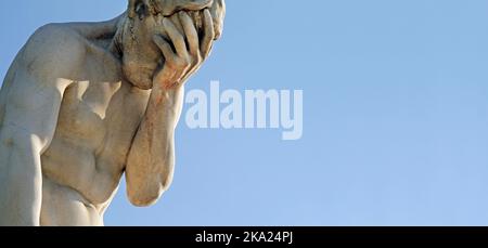 Facepalm - a statue with its head in its hand Stock Photo
