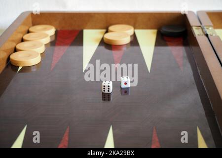 Dice in double fours position on backgammon game board. Focused on the dice. Stock Photo