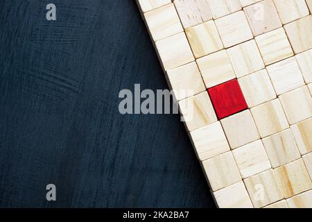 Wooden cubes and one red as a symbol of uniqueness and individuality. Stock Photo