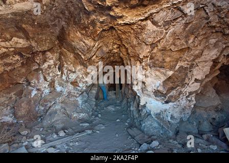 Hiker at Eureka Mine adit entrance tunnel, Mojave Desert, Death Valley National Park, California, USA Stock Photo