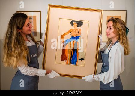 London, UK. 31st Oct, 2022. Art handlers straighten Moa (C). The Unflinching Eye of Egon Schiele: Works of a Private Collector on view at Bonhams New Bond Street, London, from Monday 31 October to Wednesday 16 November. Credit: Guy Bell/Alamy Live News Stock Photo