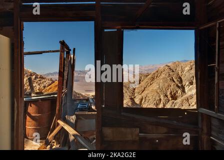 View through window frame of ruined house at Ashford Mine in Black Mountains, Mojave Desert, Death Valley National Park, California, USA Stock Photo
