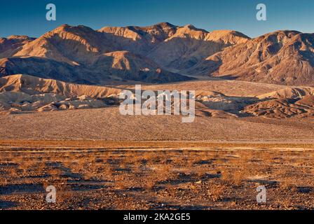 Owlshead Mountains over Confidence Hills in Mojave Desert seen at sunrise from Jubilee Pass Road, Death Valley National Park, California, USA Stock Photo
