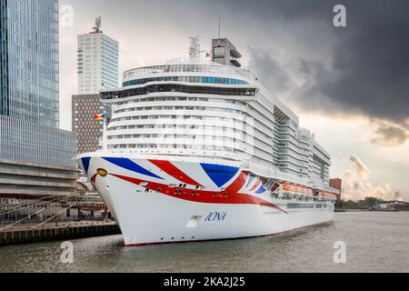 Rotterdam Cruise Terminal with Iona British new cruise ship moored, Netherlands sunset Large modern cruise P and O cruise ship with Union Jack Flag Stock Photo