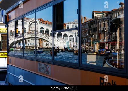 Rialto Bridge seen by reflexion in vaporetto boat stop Stock Photo