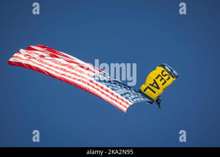 A member of the US Navy Leap Frogs parachutes in to the opening of the 2022 Miramar Airshow in San Diego, California. Stock Photo