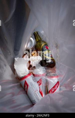 Rubbish in a litter bin on a railway station platform in England. Stock Photo