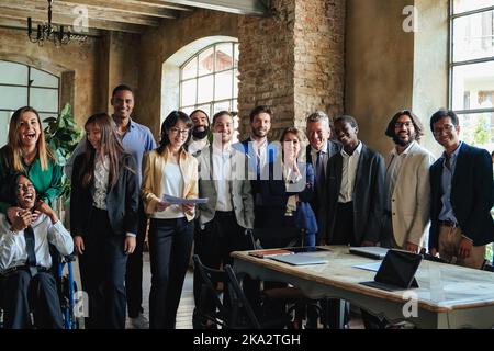 Happy multiracial business people working inside bank office - Focus on center senior woman face Stock Photo