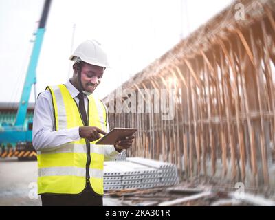 African architects engineer man with tablet work together in the inside the construction building site.Engineering concepts and technological applicat Stock Photo