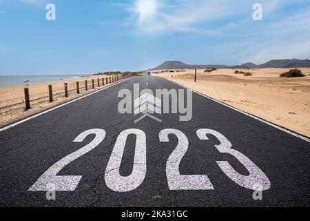 2023 New Year road trip travel and future vision concept . Nature landscape with highway road leading forward to happy new year Stock Photo