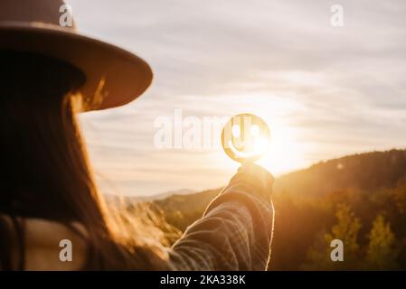 Side view of young female holding happy smile face on background amazing sunset in mountains at autumn calm day, good feedback rating and positive cus Stock Photo