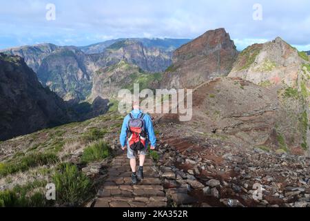 A hiker on a trail from Pico Airero to Pico Ruivo on Madeira, Portugal Stock Photo