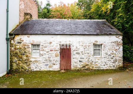 Small Irish town cottage with a sign in the window saying it will be sold by public auction. Stock Photo