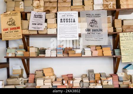 Shelves with reams of paper in an old fashioned printshop. Stock Photo