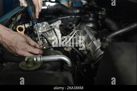 Mechanic measuring voltage of car battery Stock Photo