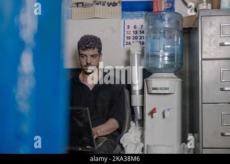 Repairman using laptop in workshop Stock Photo